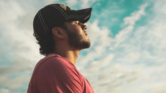 Man practicing relaxation techniques outdoors, related to how to stop mouth breathing.