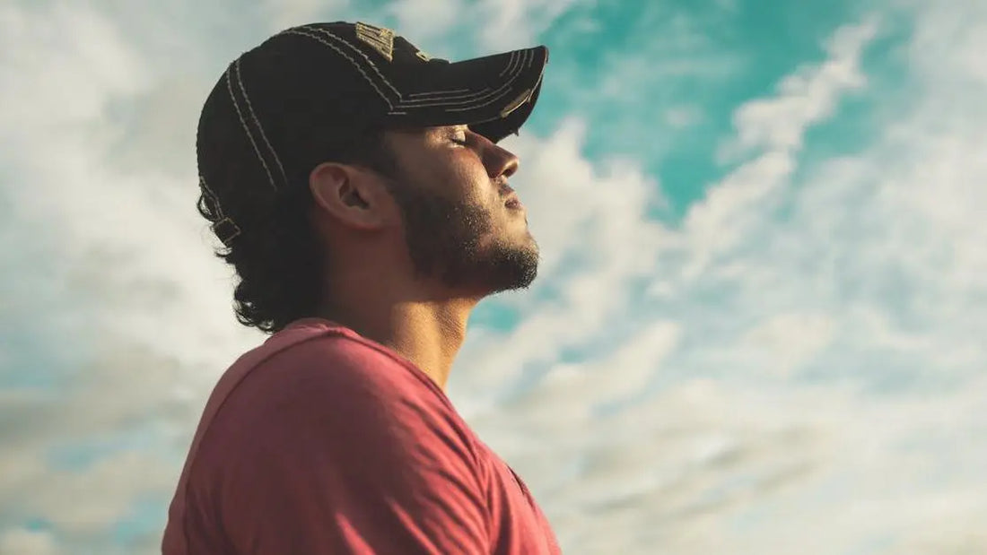 Man practicing relaxation techniques outdoors, related to how to stop mouth breathing.